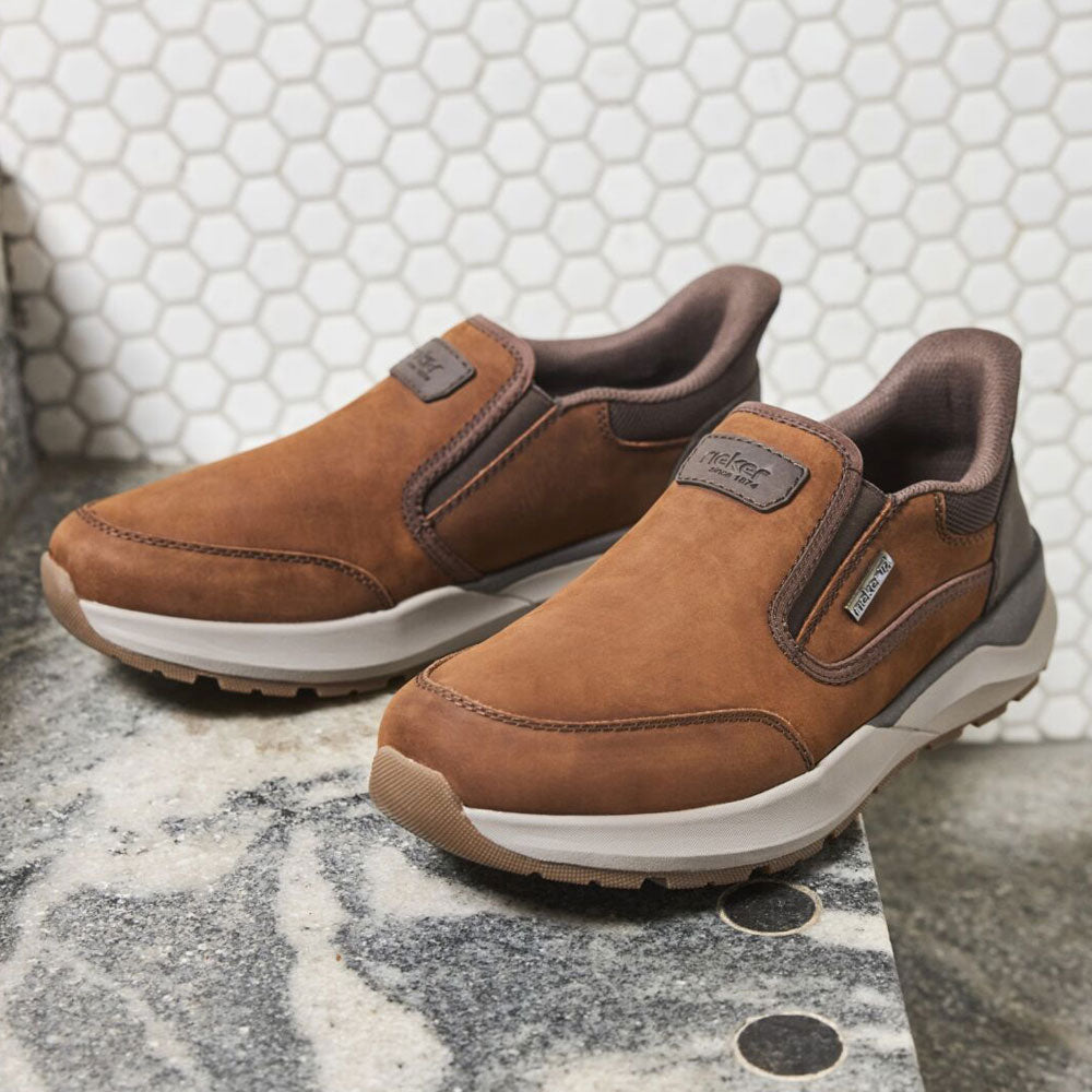 a pair of brown slip in shoes