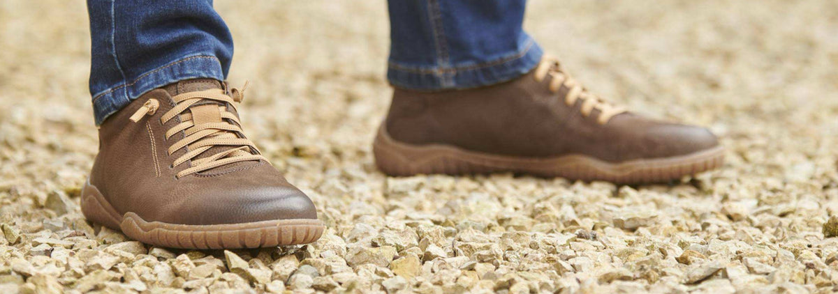 a pair of brown josef seibel shoes standing on gravel